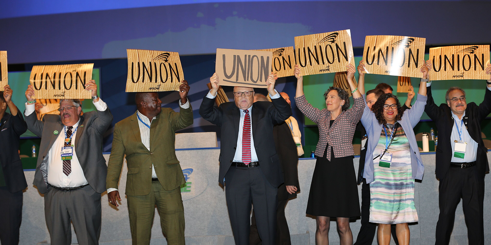 Lee Saunders, Elissa McBride and other union members hold up Union signs