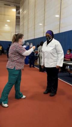 Denise Yon and Carolyn Winbush talk before their vaccination clinic shifts